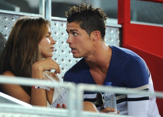 MADRID, SPAIN - AUGUST 22:  Cristiano Ronaldo (R) of Real Madrid chats with Irina Shayk while enjoying a friendly basketbal game between Spain and the USA at La Caja Magica on August 22, 2010 in Madrid, Spain.  (Photo by Jasper Juinen/Getty Images)